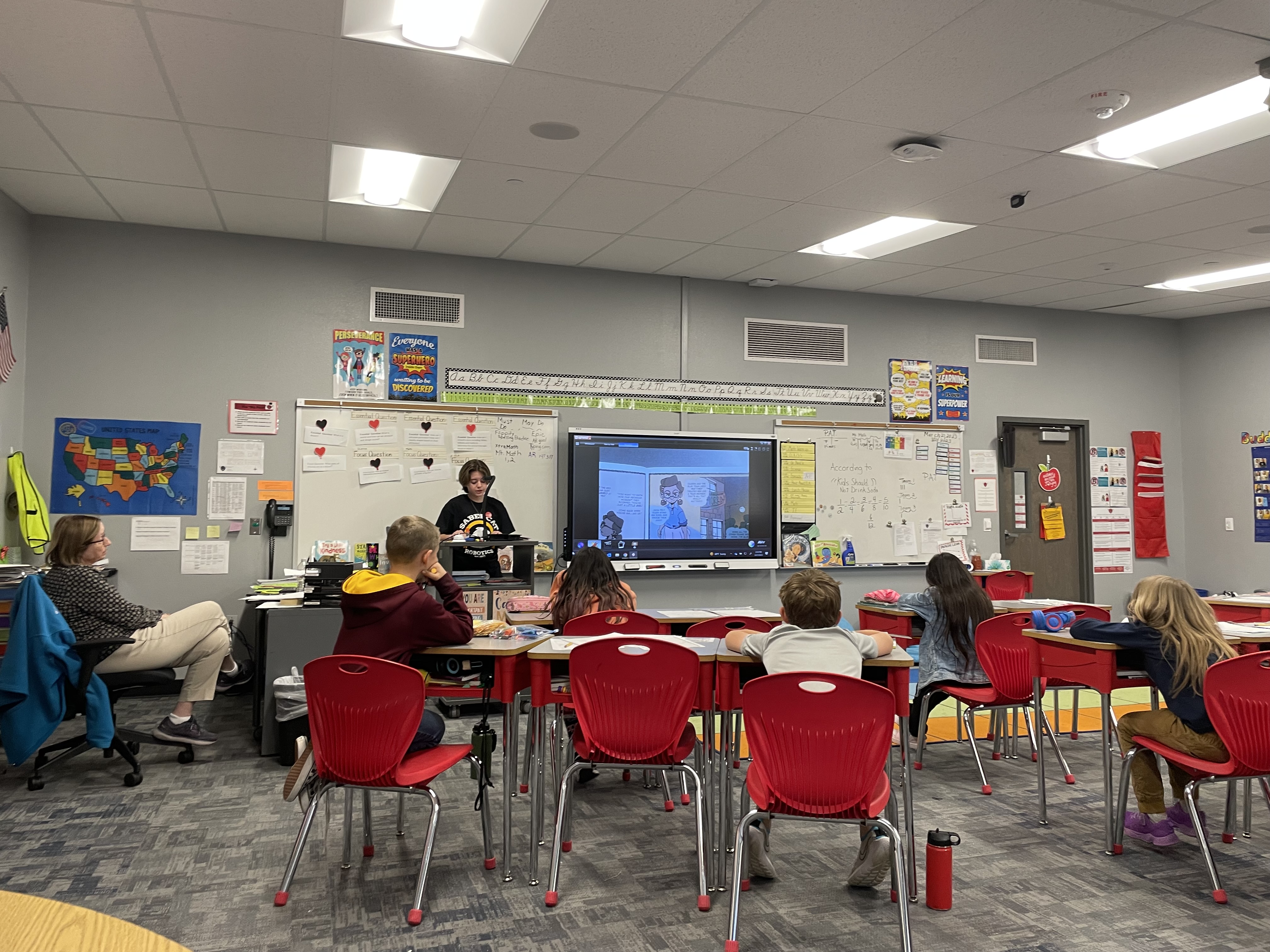 SiS volunteer reading Jada Saves the Day to elementary students